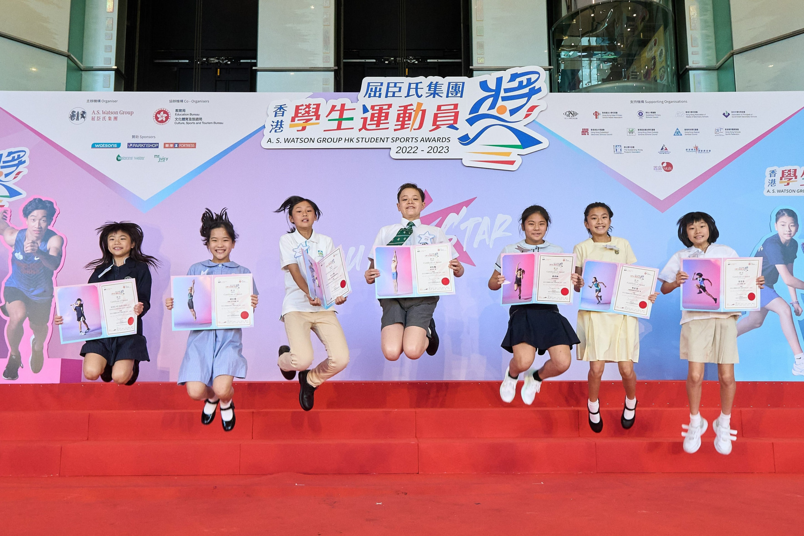 Being recognised for their achievements, student awardees smile with a glow